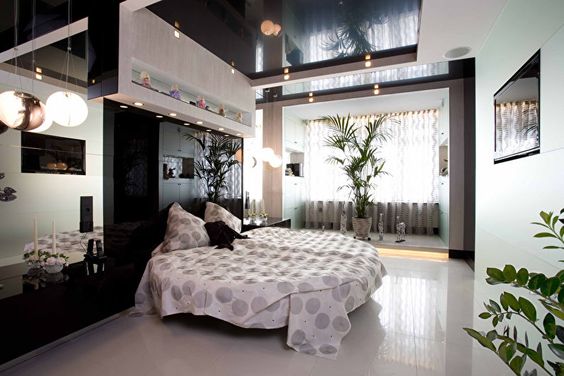 Black glossy stretch ceiling in the bedroom - photo