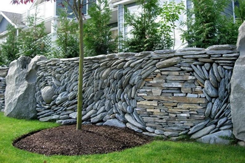 Stone fence for a private house - photo
